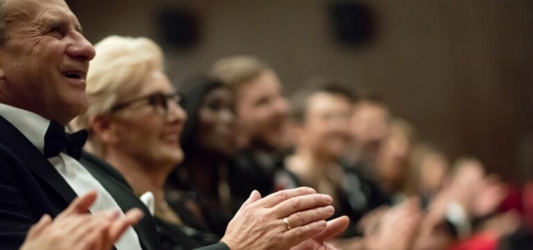 Older People clapping at a play
