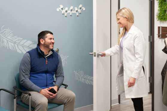 One of our expert audiologists greets a patient in our waiting room