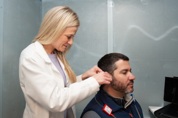 A patient receiving a hearing aid fitting at Professional Hearing Services, Inc